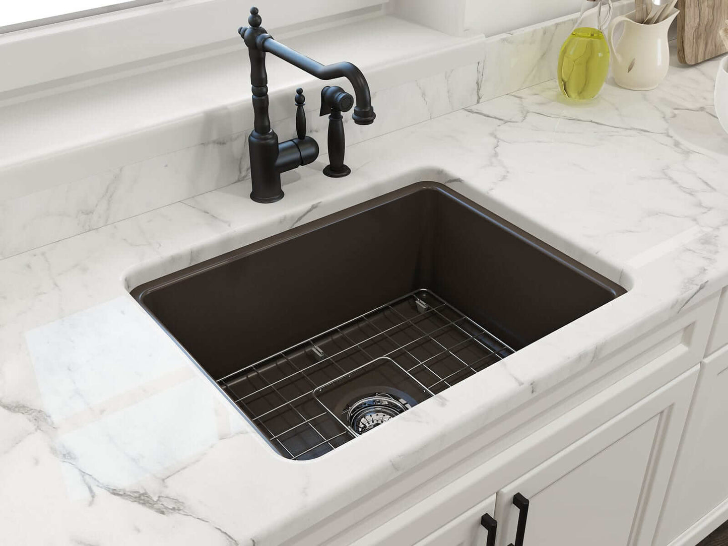 BOCCHI SOTTO 24" Fireclay Dual-Mount Single Bowl Sink with Bottom Grid & Strainer shown in dark fireclay finish on marble countertop.