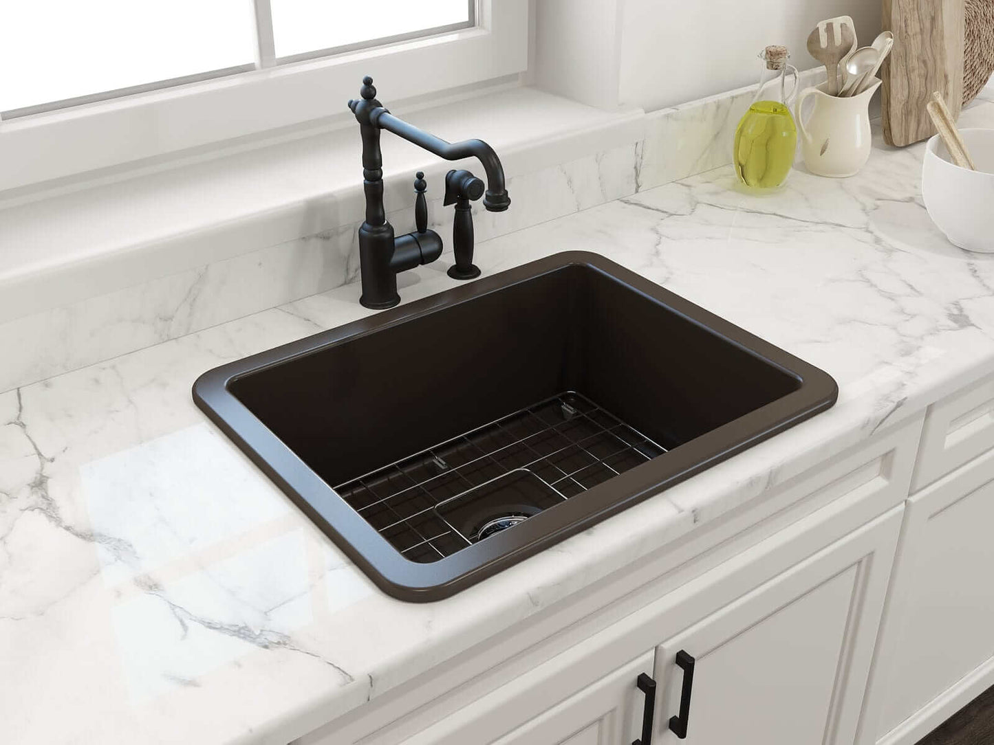 BOCCHI SOTTO 24" Fireclay Dual-Mount Single Bowl Sink with Bottom Grid & Strainer in black finish on marble countertop.
