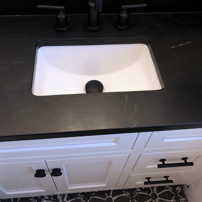 Nantucket 17.125" Undermount Ceramic Bathroom Sink UM-159-W in a stylish black countertop setting.