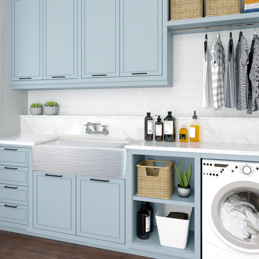 Nantucket 33" Fireclay Farmhouse with Waves - FCFS3320S-W-Waves front view in a modern kitchen with blue cabinets.