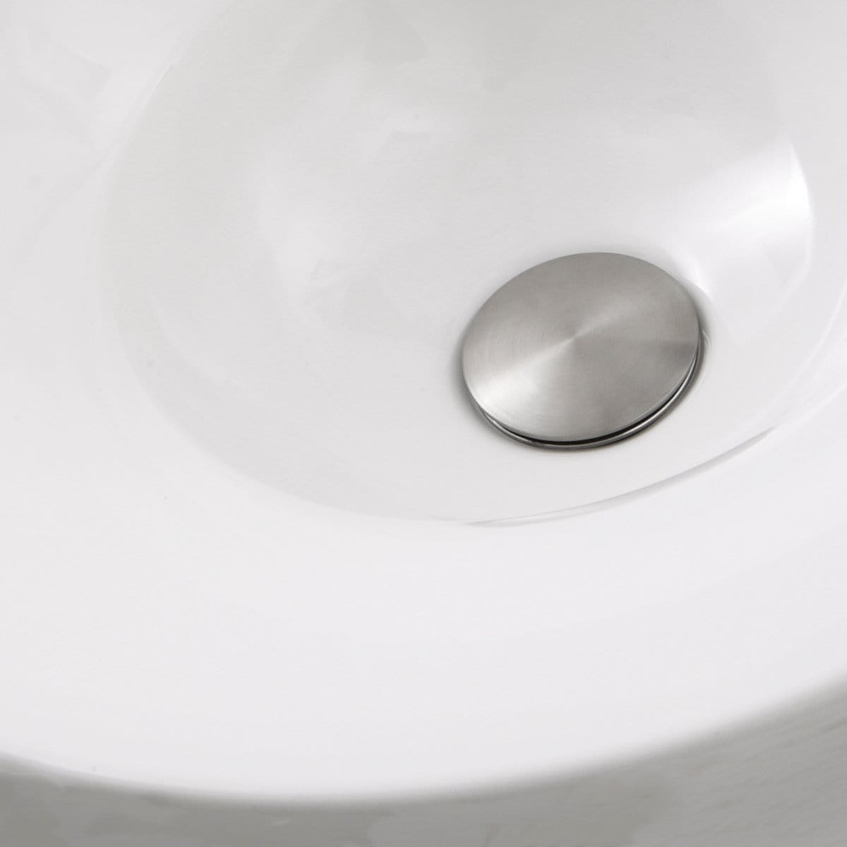 Interior view of the Nantucket Dinard Italian Fireclay Vanity Sink - RC77240W showcasing a sleek stainless steel drain cover.