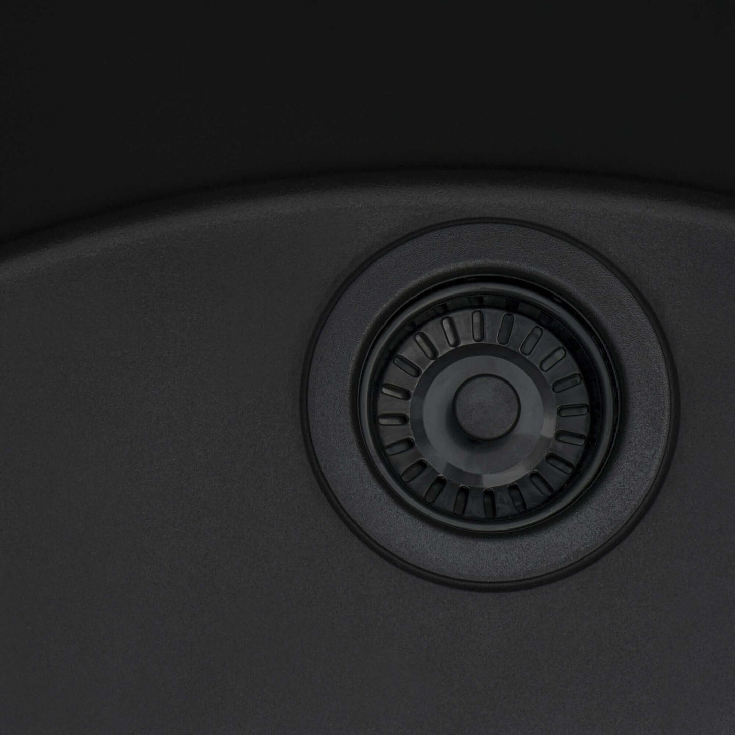 Ruvati epiGranite 22" Topmount Single Bowl Kitchen Sink RVG1022 drain detail in Midnight Black finish.
