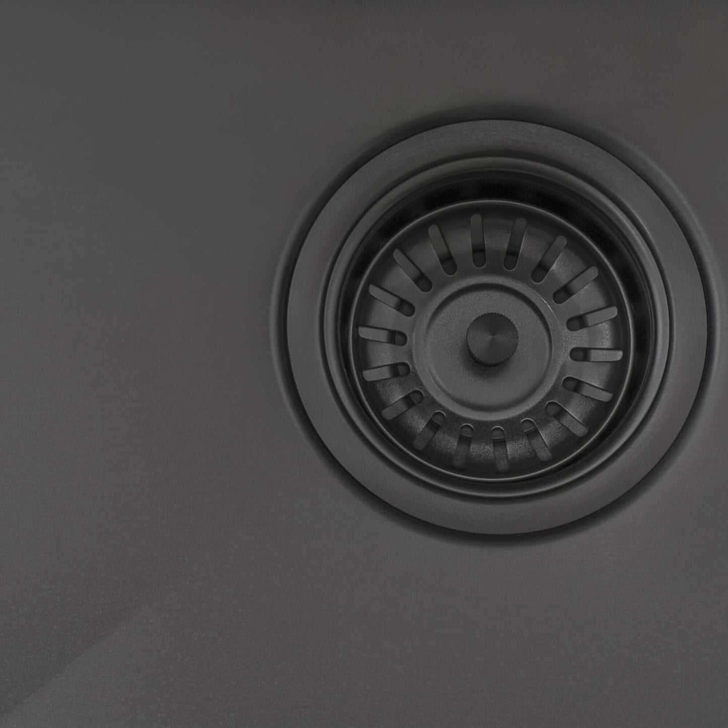 Ruvati Terraza 27" Stainless Steel Kitchen Sink RVH6127BL with black sink strainer detail.