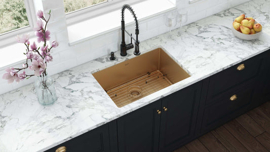 Ruvati Terraza 33" Stainless Steel Kitchen Sink RVH6433GG in matte gold finish with dark cabinetry and floral accents.