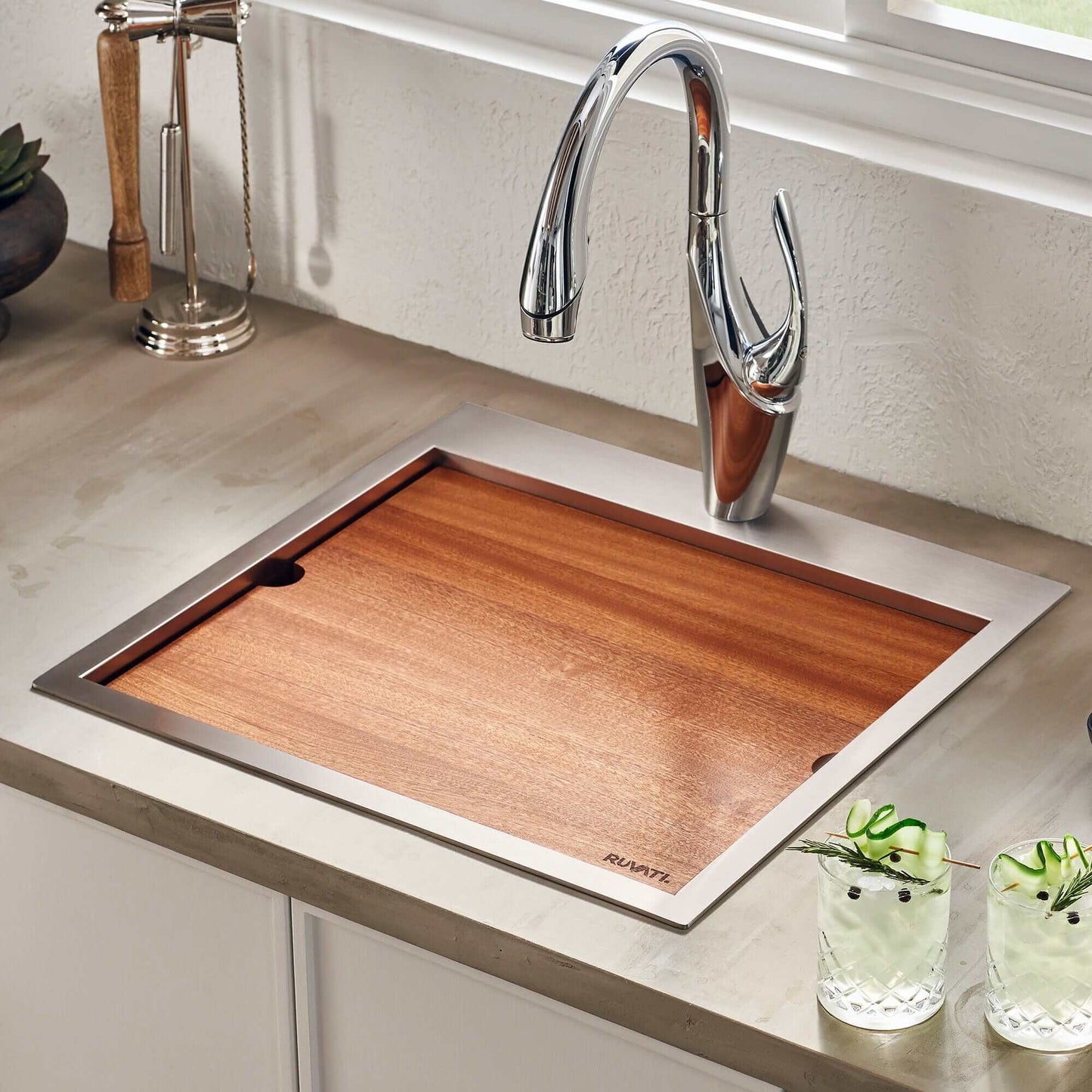 Ruvati Siena 21" RV Workstation Drop-in Stainless Steel Kitchen Sink RVH8221 with wooden cover in a modern kitchen.