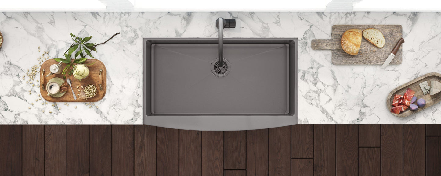 Ruvati Terraza 36" Stainless Steel Kitchen Sink RVH9880BL displayed on a marble countertop with food preparation accessories.