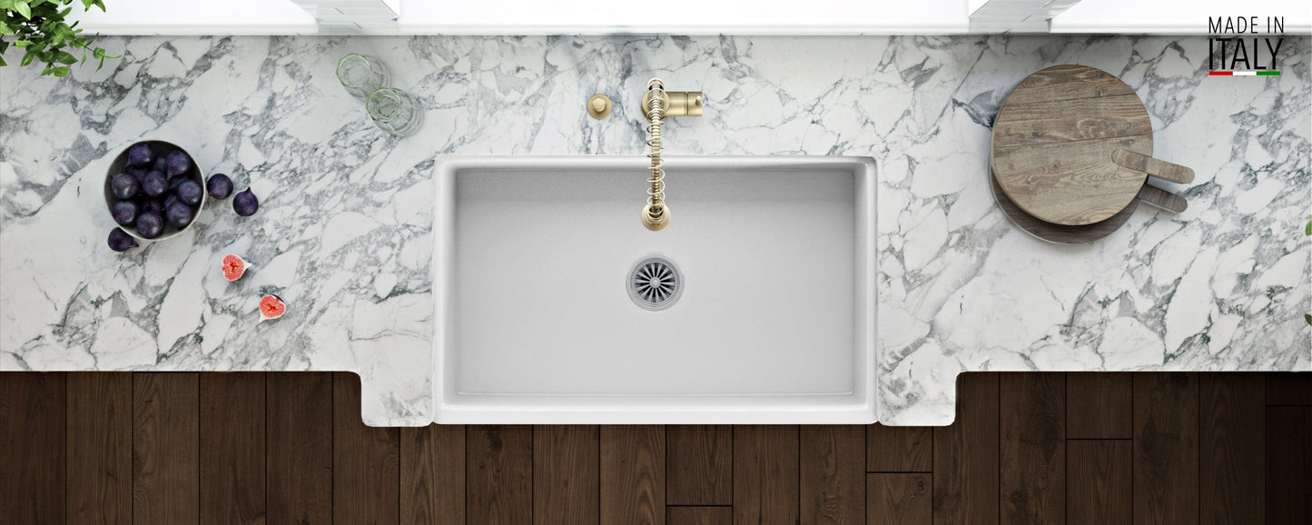 Ruvati Fiamma 33" Fireclay Kitchen Sink RVL2300WH on a marble countertop with fresh fruits.