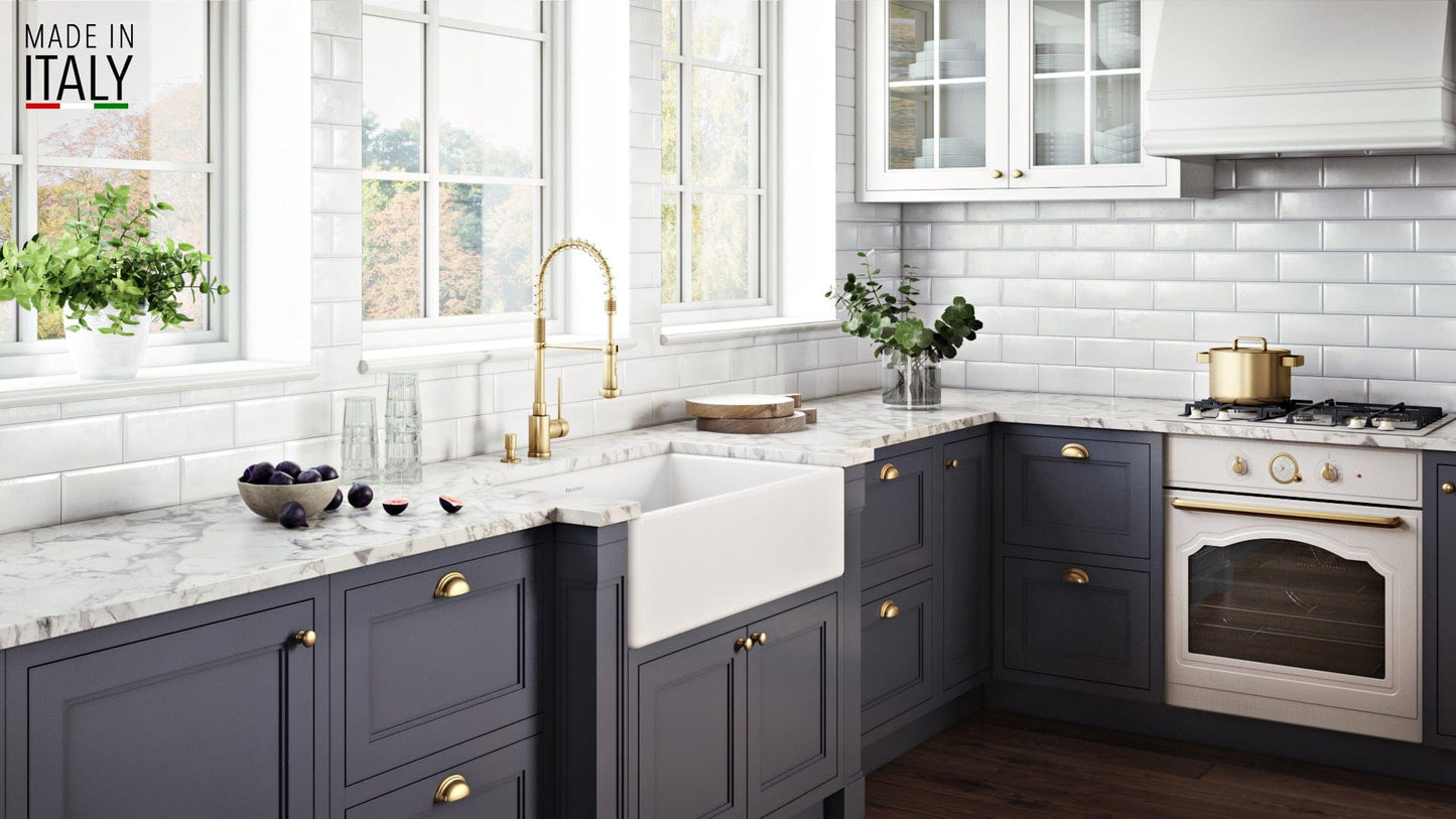 Ruvati Fiamma 33" Fireclay Kitchen Sink RVL2300WH shown in elegantly designed kitchen with marble countertops.