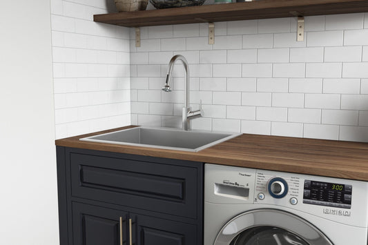 Ruvati Forma 25" Stainless Steel Laundry Utility Sink RVU6015 installed in utility room with washer and shelf.