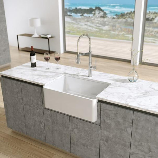 Latoscana 27" Reversible Fireclay Single Bowl Farmhouse Sink front view in modern kitchen with wine and decor.