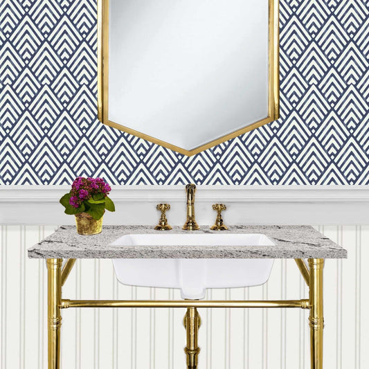 Nantucket 17" Undermount Ceramic Sink GB-17x13-W installed in a stylish bathroom with patterned wall and gold fixtures.