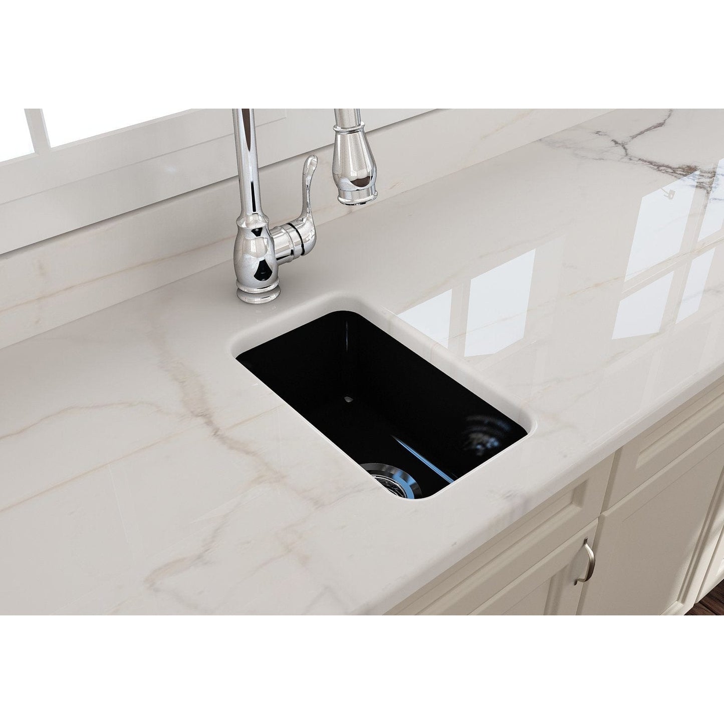 Top view of BOCCHI SOTTO 12" Fireclay Modern Undermount Single Bowl Bar Sink with Strainer on a marble countertop.
