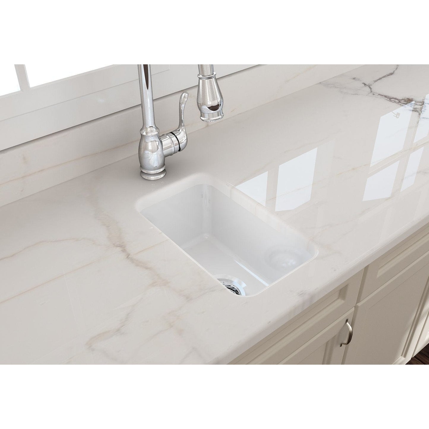 Close-up view of BOCCHI SOTTO 12" Fireclay Modern Undermount Single Bowl Bar Sink with Strainer on a marble countertop.