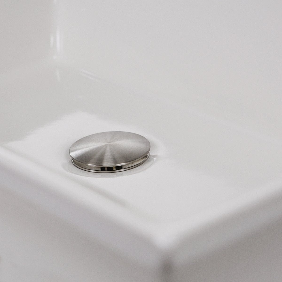 Nantucket Cannes Italian Fireclay Vanity Sink - RC73040W drain cover with sleek stainless steel finish in a white sink.