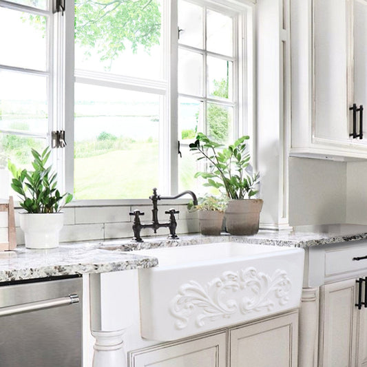 Nantucket 33" Farmhouse Fireclay Sink with Filigree Apron - FCFS3320S-Filigree in a bright kitchen with plants.