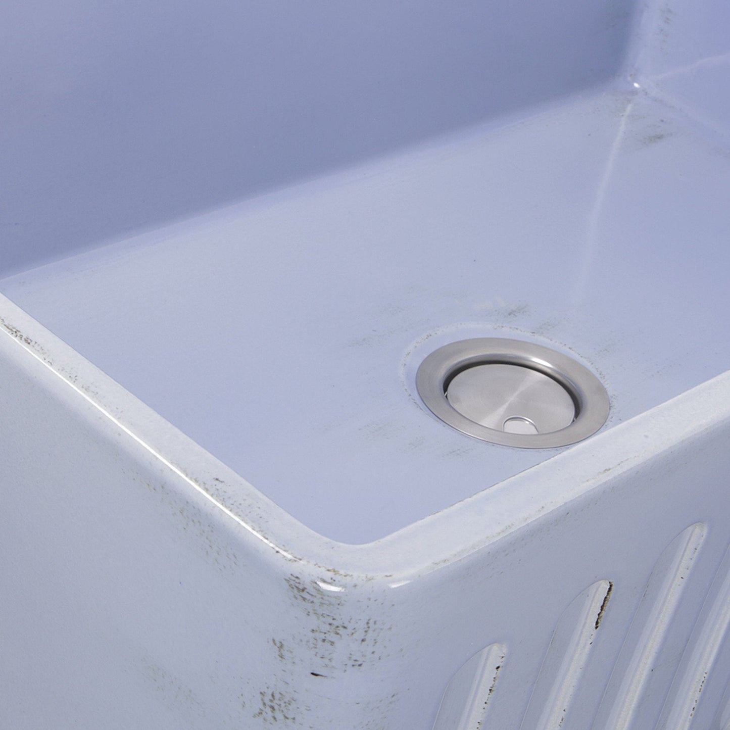 Nantucket 33" Farmhouse Fireclay Sink with Shabby Sugar Finish - FCFS3320S-ShabbySugar close-up of the sink's corner and drain.