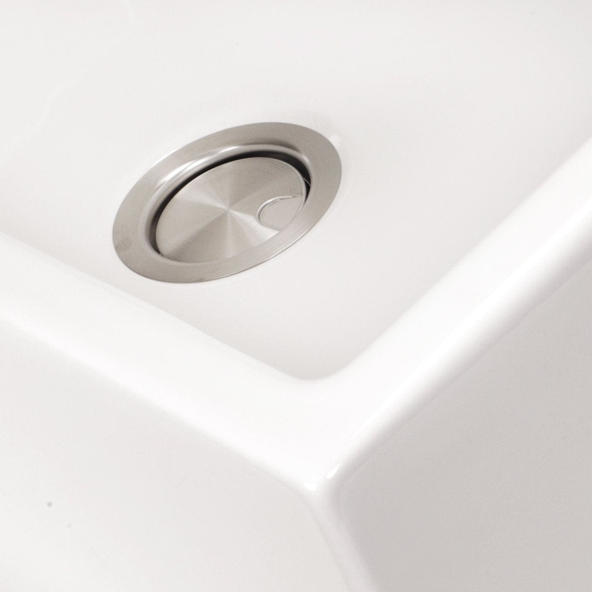 Close-up of Nantucket 33" Italian Farmhouse Fireclay Sink - Harwich-33 showcasing the modern drain design.