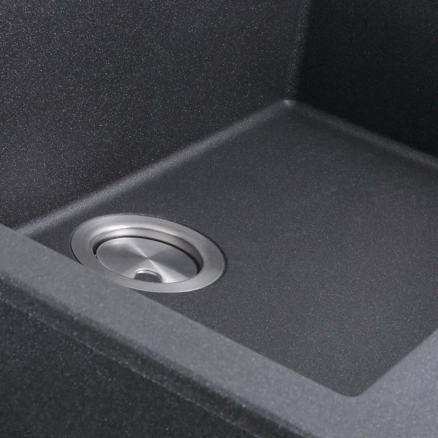 Nantucket Large Single Bowl Dual-Mount Granite Composite Black close-up of sink drain in a spacious black sink interior.