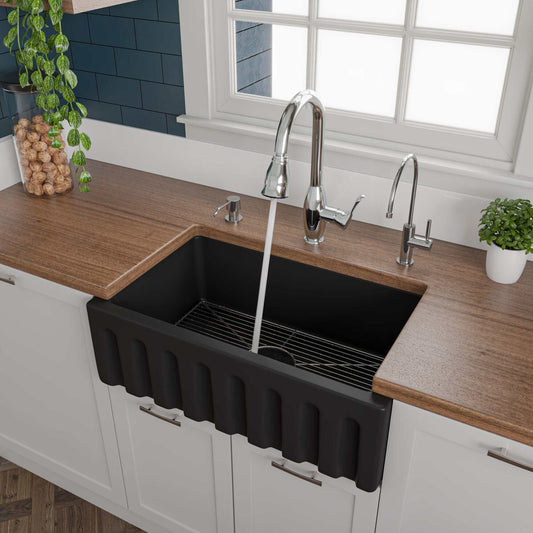ALFI 30" Black Matte Reversible Fireclay Farmhouse Sink displayed in a modern kitchen with a wooden countertop.
