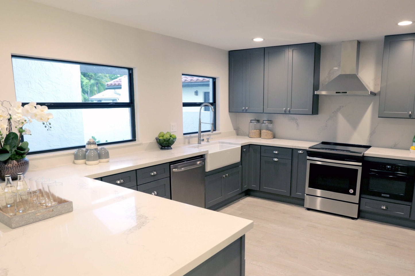 Modern kitchen featuring ALFI 33" White Smooth Apron Fireclay Farmhouse Sink and stylish gray cabinets.