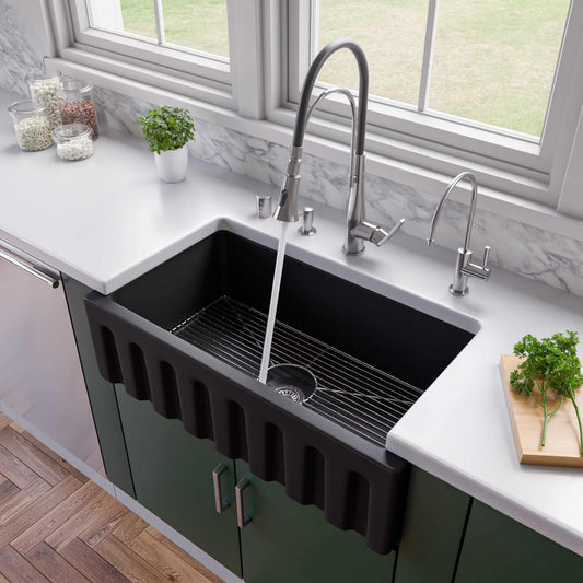 ALFI 33" Black Matte Reversible Smooth / Fluted Single Bowl Fireclay Farm Sink AB3318HS-BM in a modern kitchen.