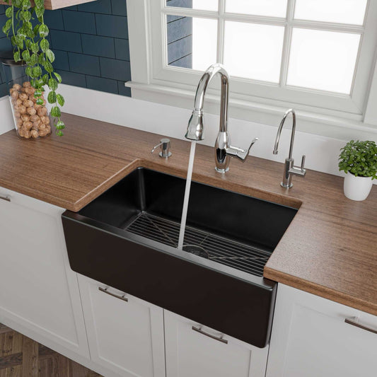 ALFI 30" Black Gloss Reversible Fireclay Farmhouse Sink with modern faucet and wooden countertop.