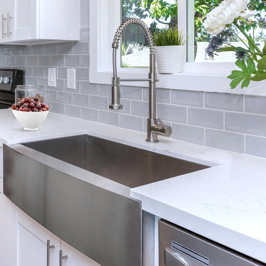 Nantucket 33" Pro Series Single Bowl Farmhouse Apron Front Stainless Steel Kitchen Sink - APRON332010-16 viewed from an angle with modern faucet and decor.