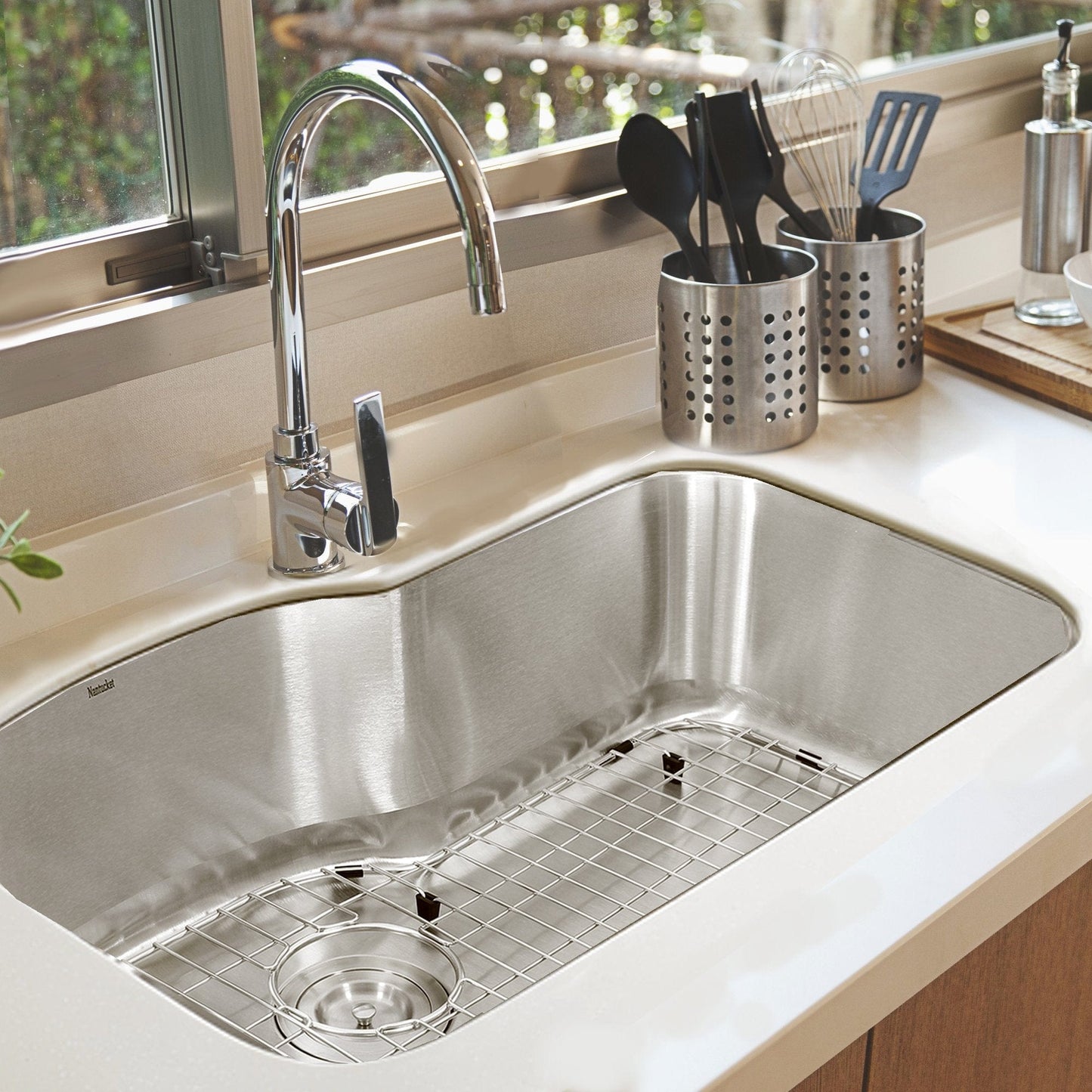Nantucket Single Bowl Oblong Undermount Stainless Steel Kitchen Sink, 16 Gauge - MOBYXL-16 with a modern faucet and utensils.