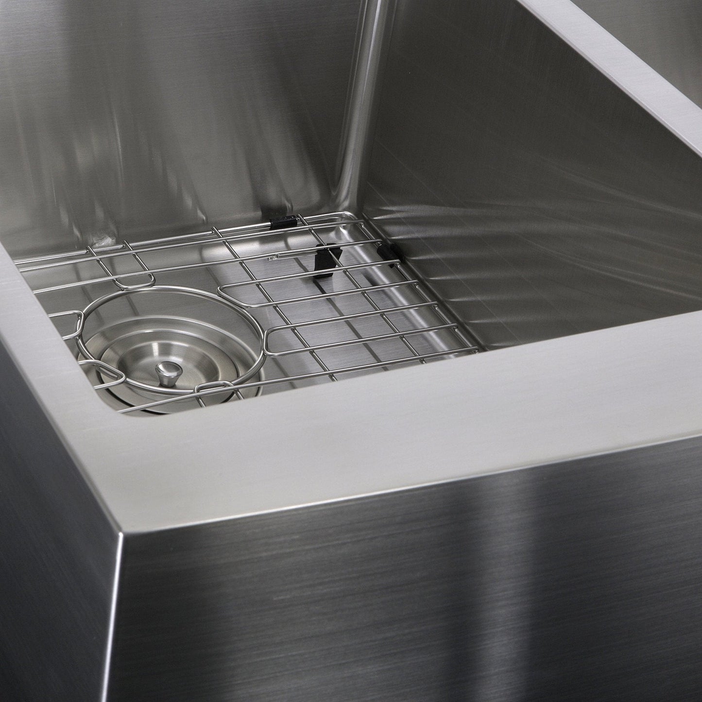 Close-up view of Nantucket 33" Double Bowl Farmhouse Apron Front Stainless Steel Kitchen Sink - APRON332210-DBL-SR with grid and drain.