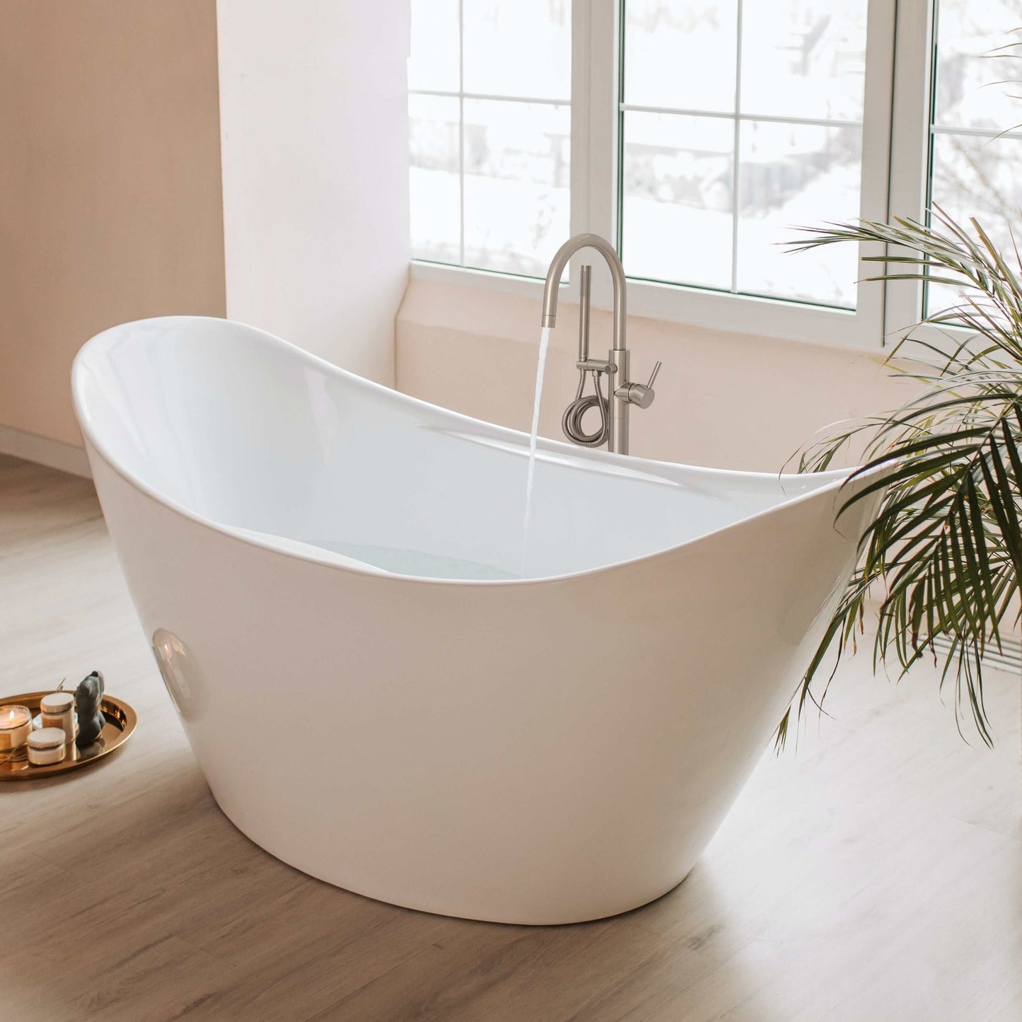 ZLINE Emerald Bay Bath Tub Filler installed in a modern bathroom with natural light and plants.